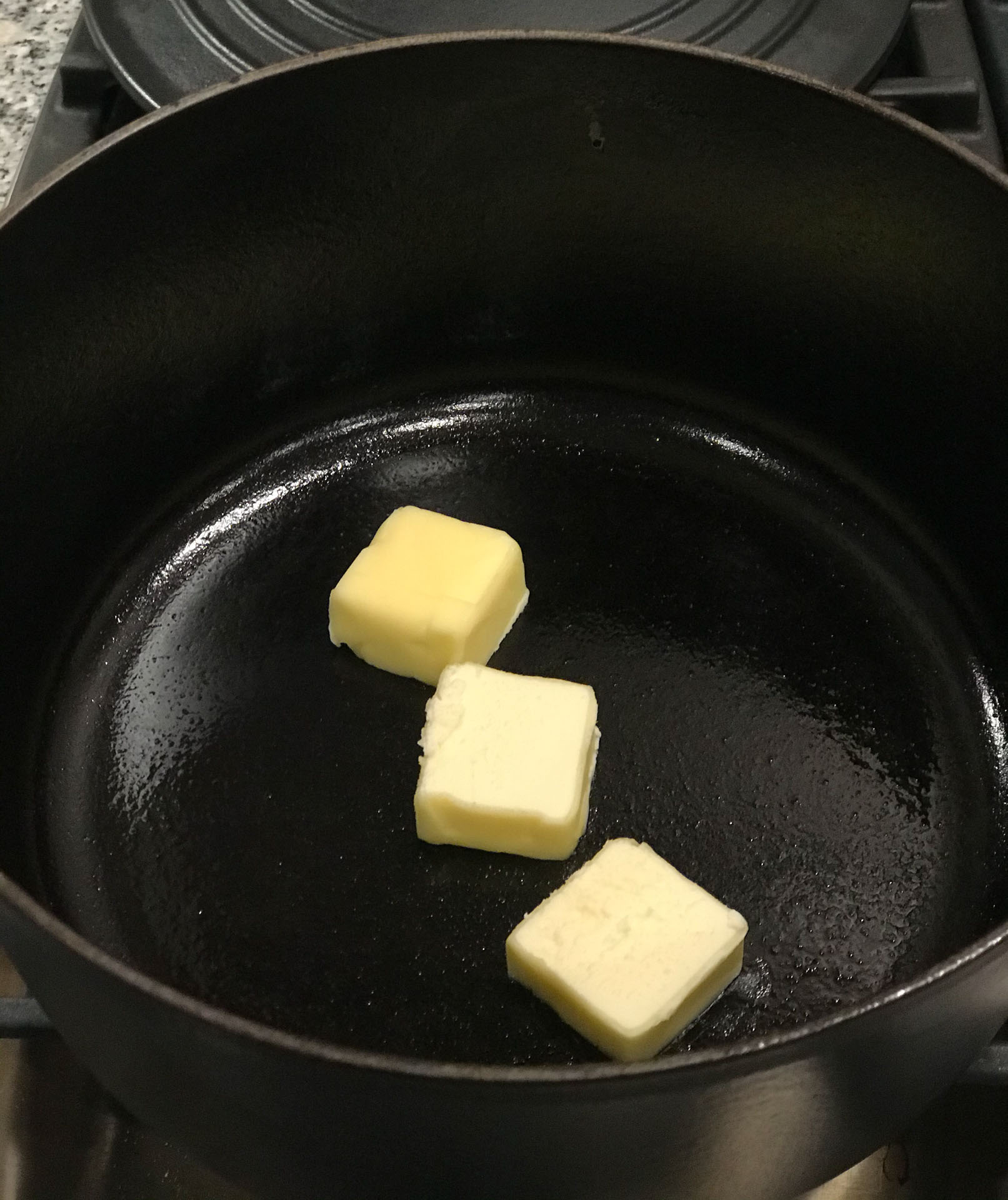 3 tablespoons of butter melting in a cast iron pan