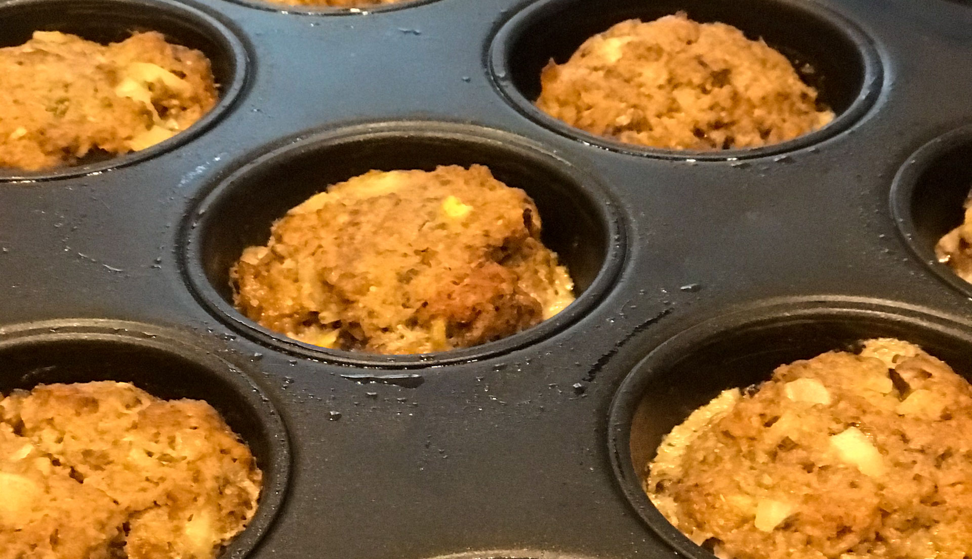 cooked mini meatloaves in muffin tin