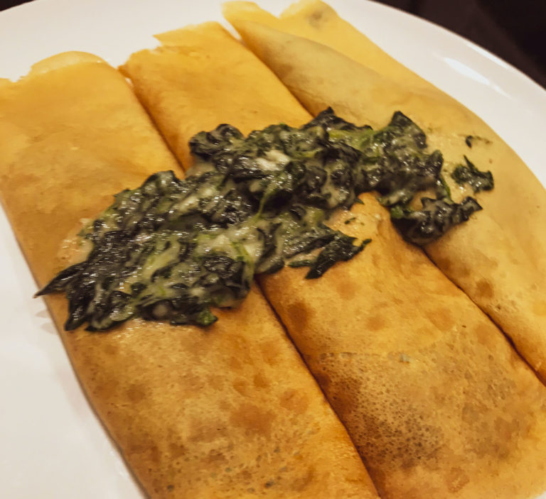 spinach crepes on a white plate