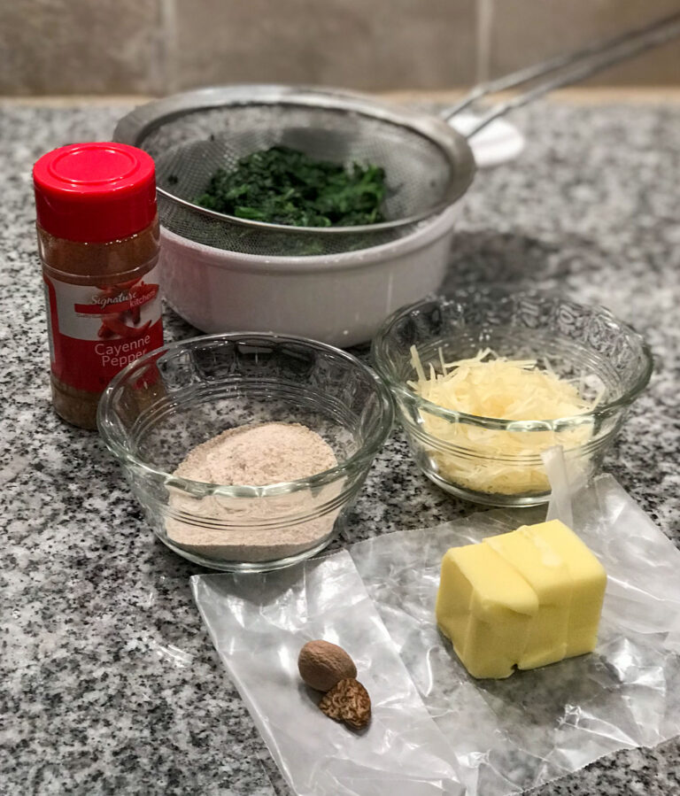 jar of cayenne pepper, cooked and drained spinach, custard cup of whole wheat flour, custard cup of grated parmesan, one whole clove, 3 tablespoons of butter